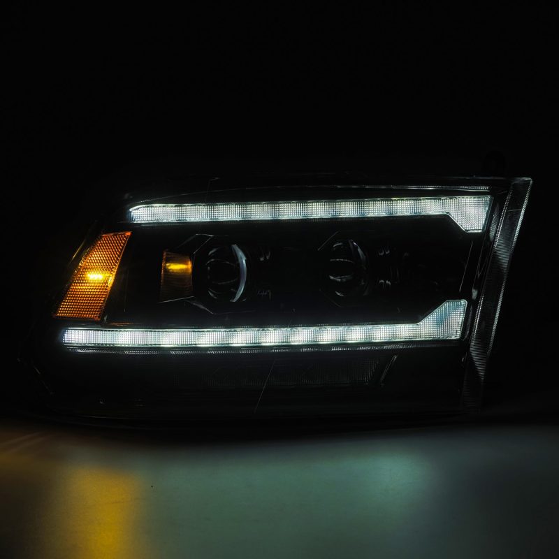 AlphaRex 09-18 Ram 2500 LUXX LED Proj Headlight Plank Style Alpha Blk w/Activ Light/Seq Signal/DRL-Headlights-Deviate Dezigns (DV8DZ9)